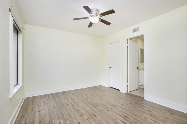 611 Colonial Cir, Fullerton, CA 92835 - unfurnished bedroom featuring light wood-style flooring, baseboards, and ensuite bathroom