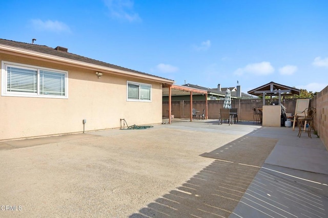 4241 Hamilton Ave, Oxnard, CA 93033 - back of house with a fenced backyard, stucco siding, and a patio area