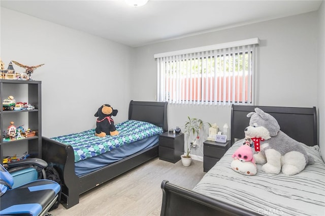 bedroom featuring wood finished floors and baseboards
