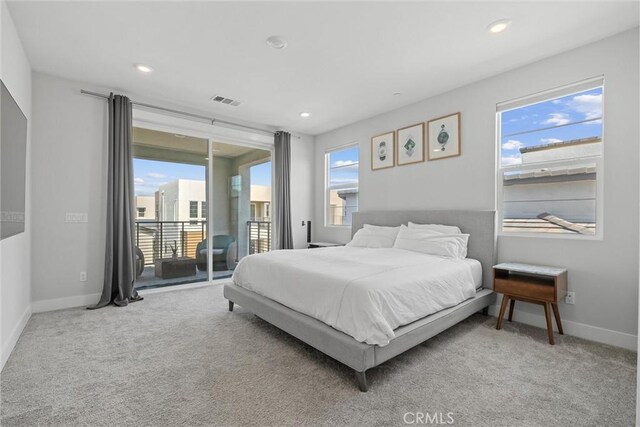 carpeted bedroom featuring access to outside, baseboards, and recessed lighting
