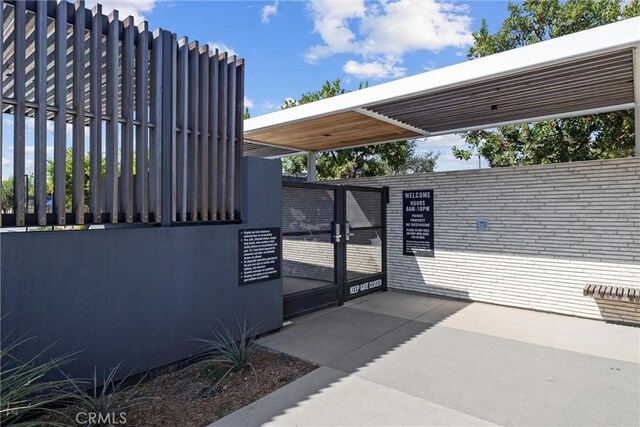 view of patio featuring a gate and fence