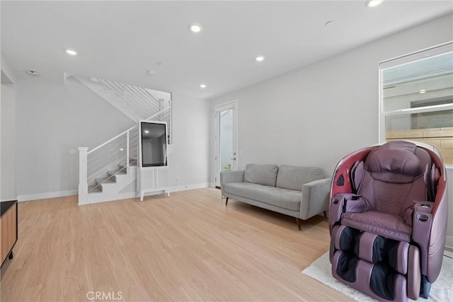 living area with stairs, light wood-style flooring, recessed lighting, and baseboards