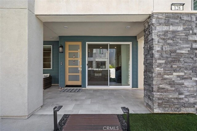 property entrance with stucco siding