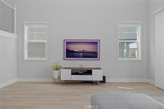 living area with wood finished floors and baseboards