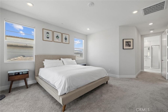 bedroom with light carpet, recessed lighting, and baseboards