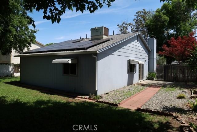 819 Sherwood Way, Willows, CA 95988 - rear view of house featuring a chimney and solar panels