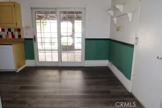 819 Sherwood Way, Willows, CA 95988 - unfurnished dining area featuring dark wood-style flooring and baseboards