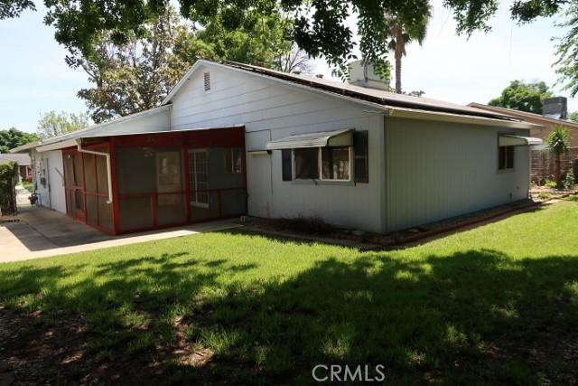 819 Sherwood Way, Willows, CA 95988 - back of house with a sunroom, a yard, and a chimney