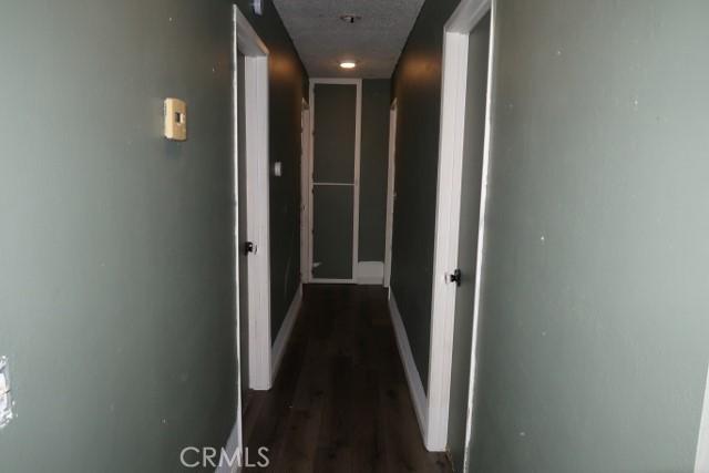 819 Sherwood Way, Willows, CA 95988 - hall with dark wood-style flooring and baseboards