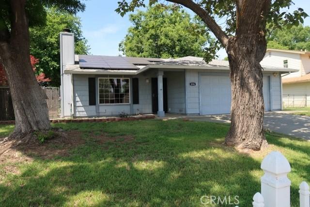 819 Sherwood Way, Willows, CA 95988 - ranch-style home with an attached garage, a chimney, solar panels, and driveway