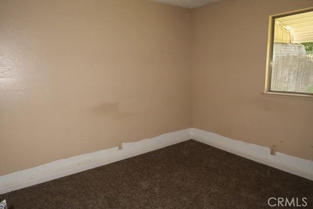 819 Sherwood Way, Willows, CA 95988 - unfurnished room featuring dark carpet and baseboards
