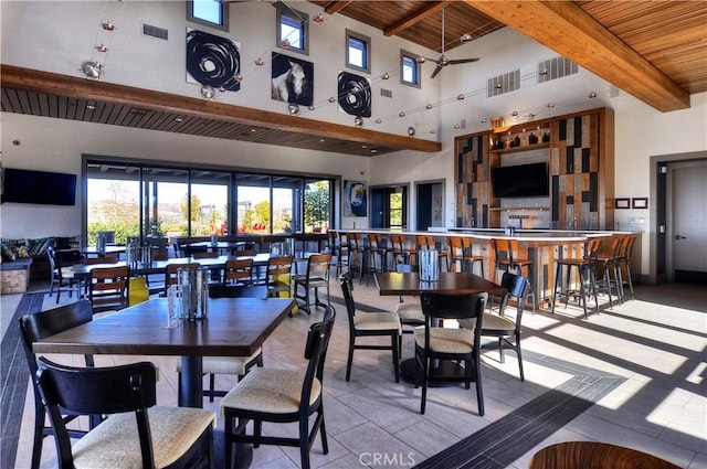 204 Alienta Ln, Rancho Mission Viejo, CA 92694 - tiled dining room featuring a wood ceiling with exposed beams, a high ceiling, plenty of natural light, and a ceiling fan