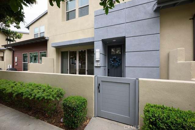 204 Alienta Ln, Rancho Mission Viejo, CA 92694 - doorway to property with stucco siding and a gate