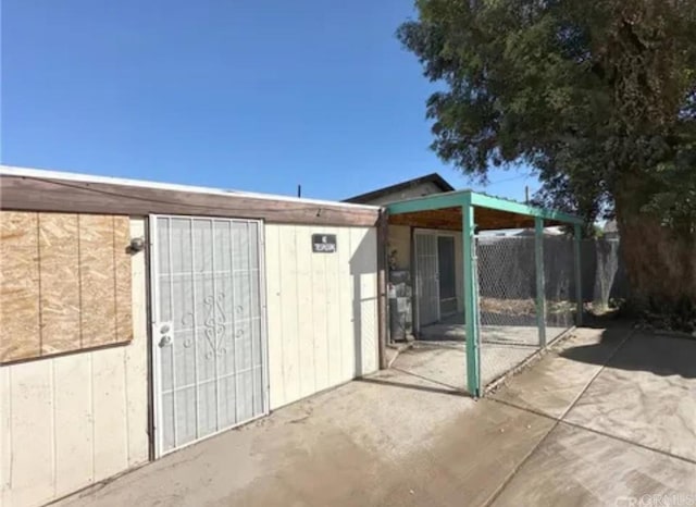 view of outbuilding with fence