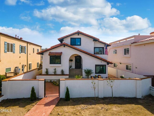 5304 Whitecap St, Oxnard, CA 93035 - mediterranean / spanish house with a fenced front yard, a gate, and stucco siding