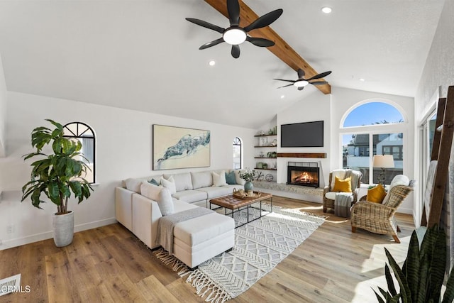 5304 Whitecap St, Oxnard, CA 93035 - living area with plenty of natural light, beamed ceiling, a ceiling fan, a tile fireplace, and wood finished floors