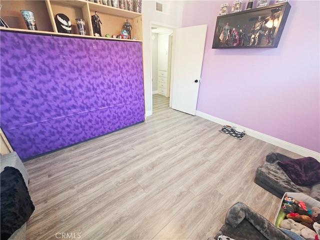 unfurnished room with wood finished floors and baseboards