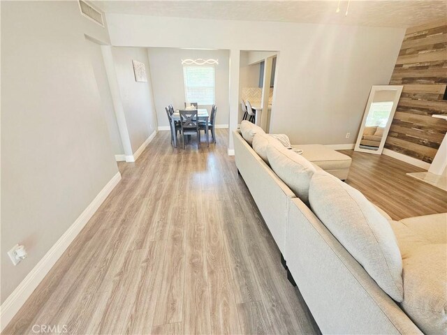 living area with light wood-style floors and baseboards