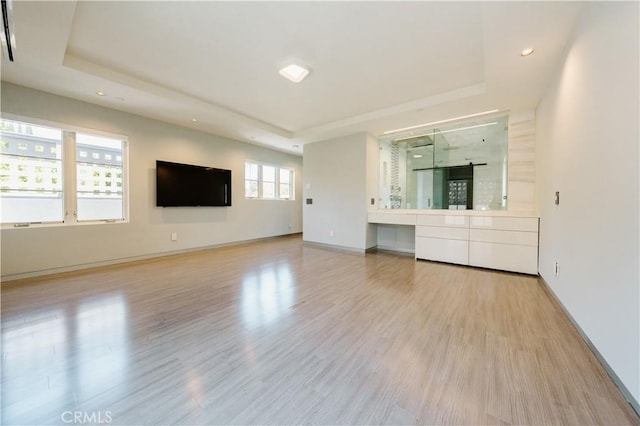 1873 S Los Robles Ave, San Marino, CA 91108 - unfurnished living room featuring a tray ceiling, light wood-type flooring, recessed lighting, and baseboards