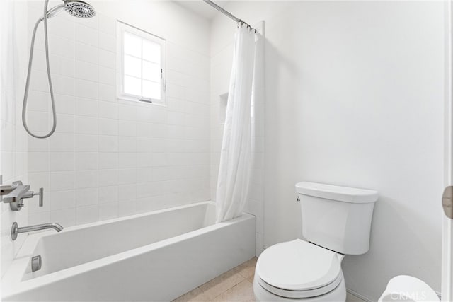 bathroom featuring toilet, shower / bath combination with curtain, and tile patterned flooring