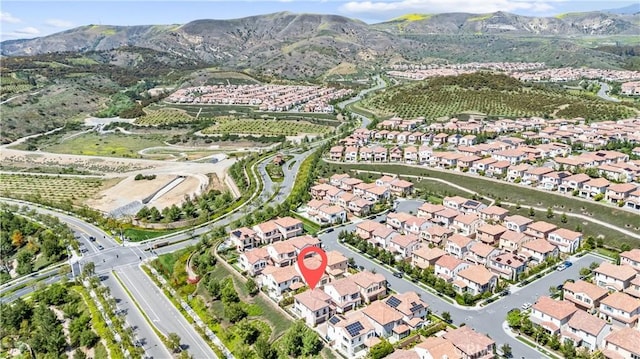aerial overview of property's location featuring a mountain backdrop and nearby suburban area