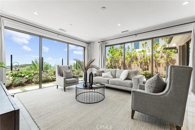 tiled living area featuring recessed lighting