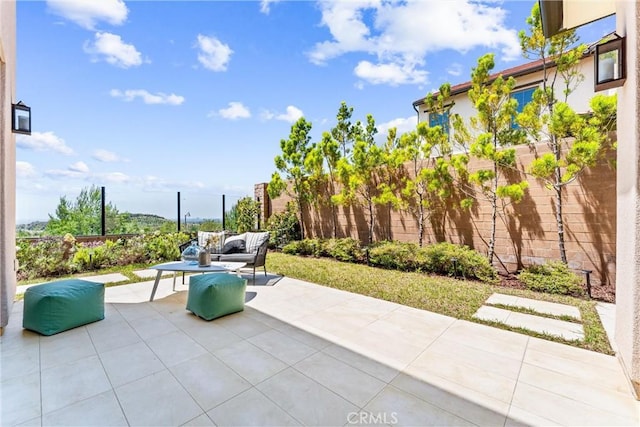 view of patio featuring fence and an outdoor living space
