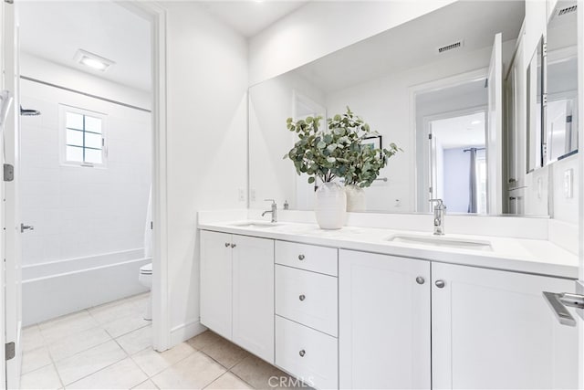 full bathroom featuring tile patterned floors, double vanity, toilet, and shower / bath combination