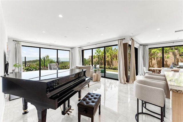 living area featuring light marble finish floors and recessed lighting