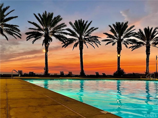 view of pool at dusk