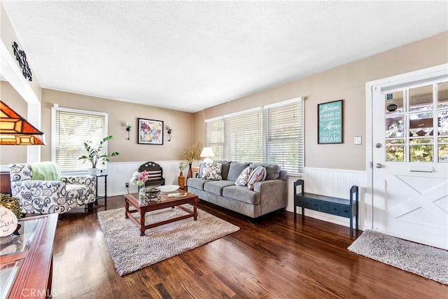 4702 Castana Ave, Lakewood, CA 90712 - living room featuring healthy amount of natural light, wainscoting, and dark wood-style flooring