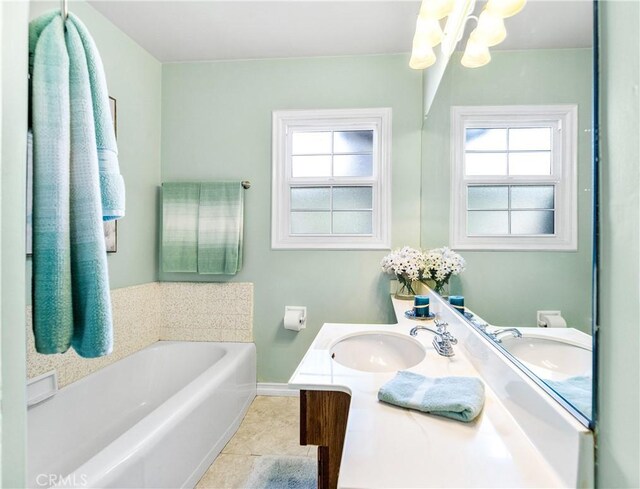 4702 Castana Ave, Lakewood, CA 90712 - bathroom featuring a chandelier, a bath, vanity, baseboards, and tile patterned floors