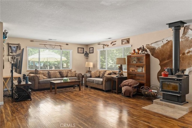 6176 Some Way, Magalia, CA 95954 - living area featuring wood finished floors, a textured ceiling, and a wood stove