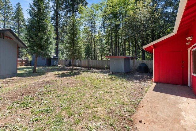 6176 Some Way, Magalia, CA 95954 - fenced backyard featuring a storage unit and an outbuilding