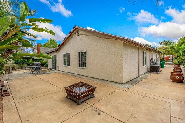 252 Worthington St, Spring Valley, CA 91977 - view of home's exterior featuring a fire pit, stucco siding, and a patio