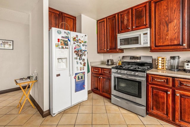 252 Worthington St, Spring Valley, CA 91977 - kitchen with white appliances, dark brown cabinets, and light tile patterned flooring