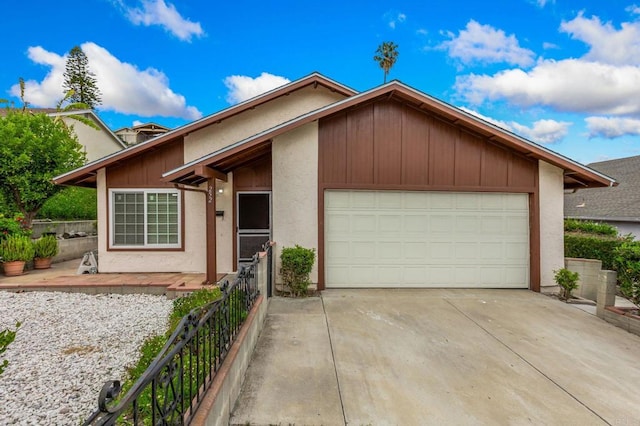 252 Worthington St, Spring Valley, CA 91977 - view of front of house featuring an attached garage, driveway, stucco siding, and fence