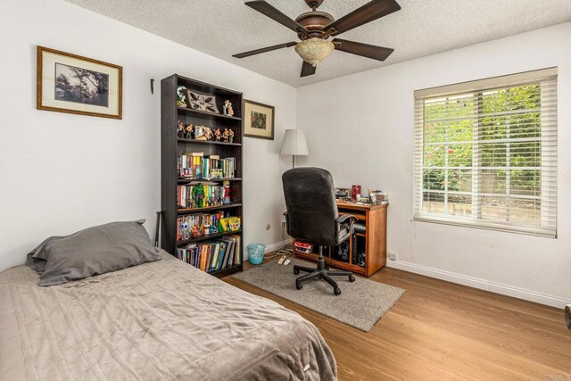 252 Worthington St, Spring Valley, CA 91977 - bedroom with wood finished floors, baseboards, a textured ceiling, an office area, and a ceiling fan