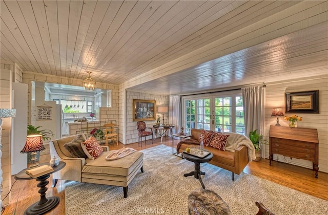 living room featuring wood finished floors, wood walls, and wood ceiling