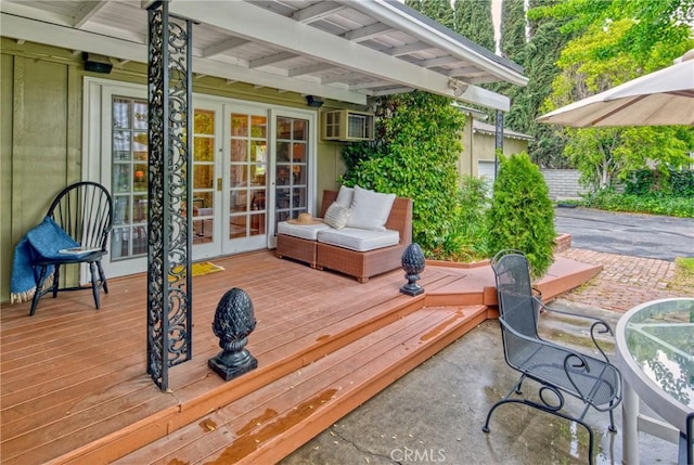 wooden terrace featuring french doors, a wall unit AC, and a patio