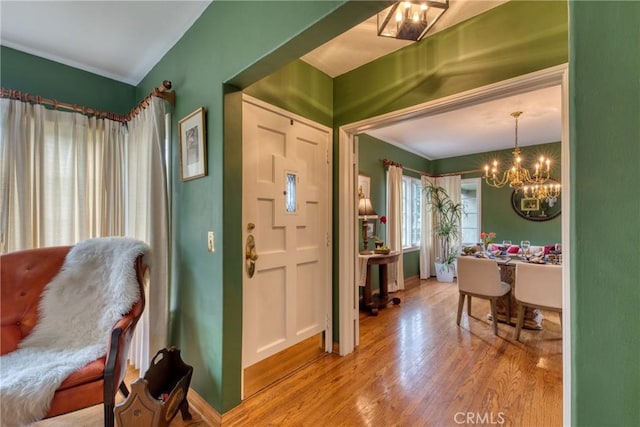 foyer featuring a chandelier and wood finished floors