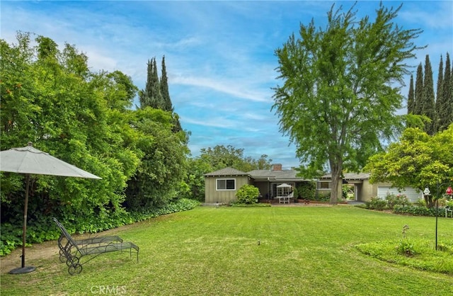 view of grassy yard with a garage