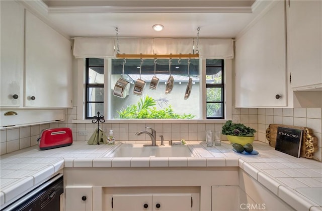 kitchen featuring ornamental molding, tasteful backsplash, and white cabinets
