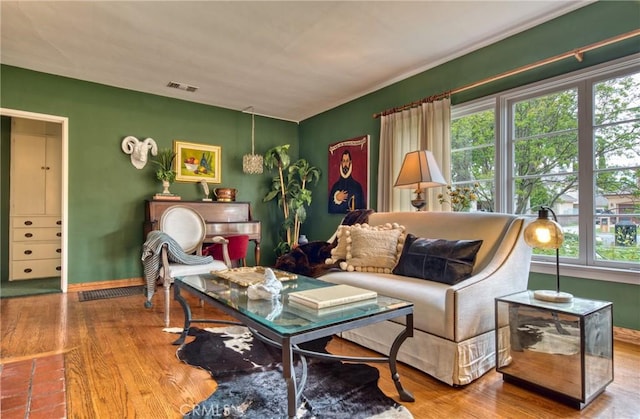 living room with plenty of natural light, wood finished floors, and baseboards