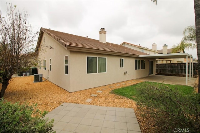 1680 Elmbridge Ln, Hemet, CA 92545 - back of property featuring a patio area, stucco siding, a chimney, cooling unit, and fence