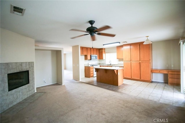 1680 Elmbridge Ln, Hemet, CA 92545 - kitchen featuring white range with gas stovetop, stainless steel microwave, a sink, a ceiling fan, and light countertops
