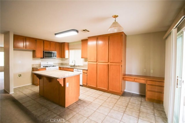 1680 Elmbridge Ln, Hemet, CA 92545 - kitchen featuring white appliances, light countertops, a sink, light tile patterned floors, and a center island