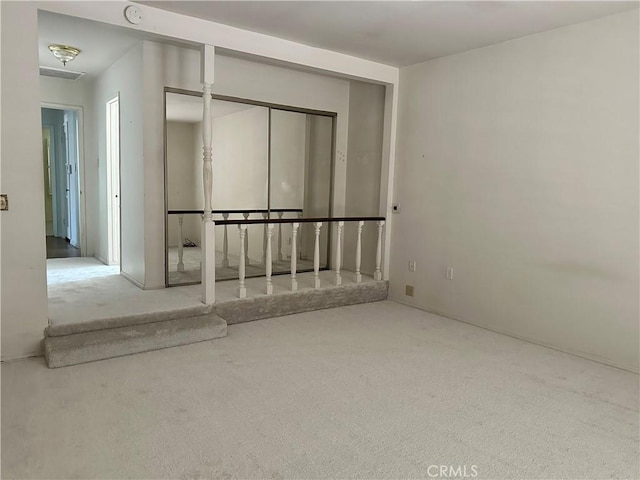 carpeted spare room with a smoke detector