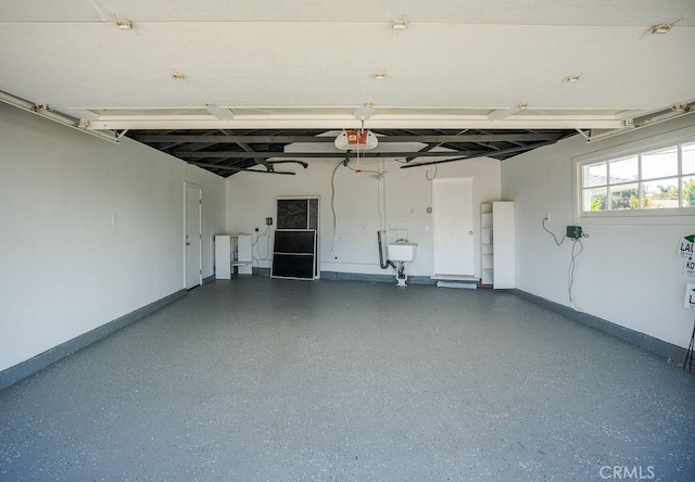18211 Fairhaven Ave, North Tustin, CA 92705 - garage with baseboards and a garage door opener