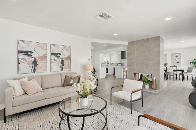 18211 Fairhaven Ave, North Tustin, CA 92705 - living room with light wood finished floors, recessed lighting, and baseboards